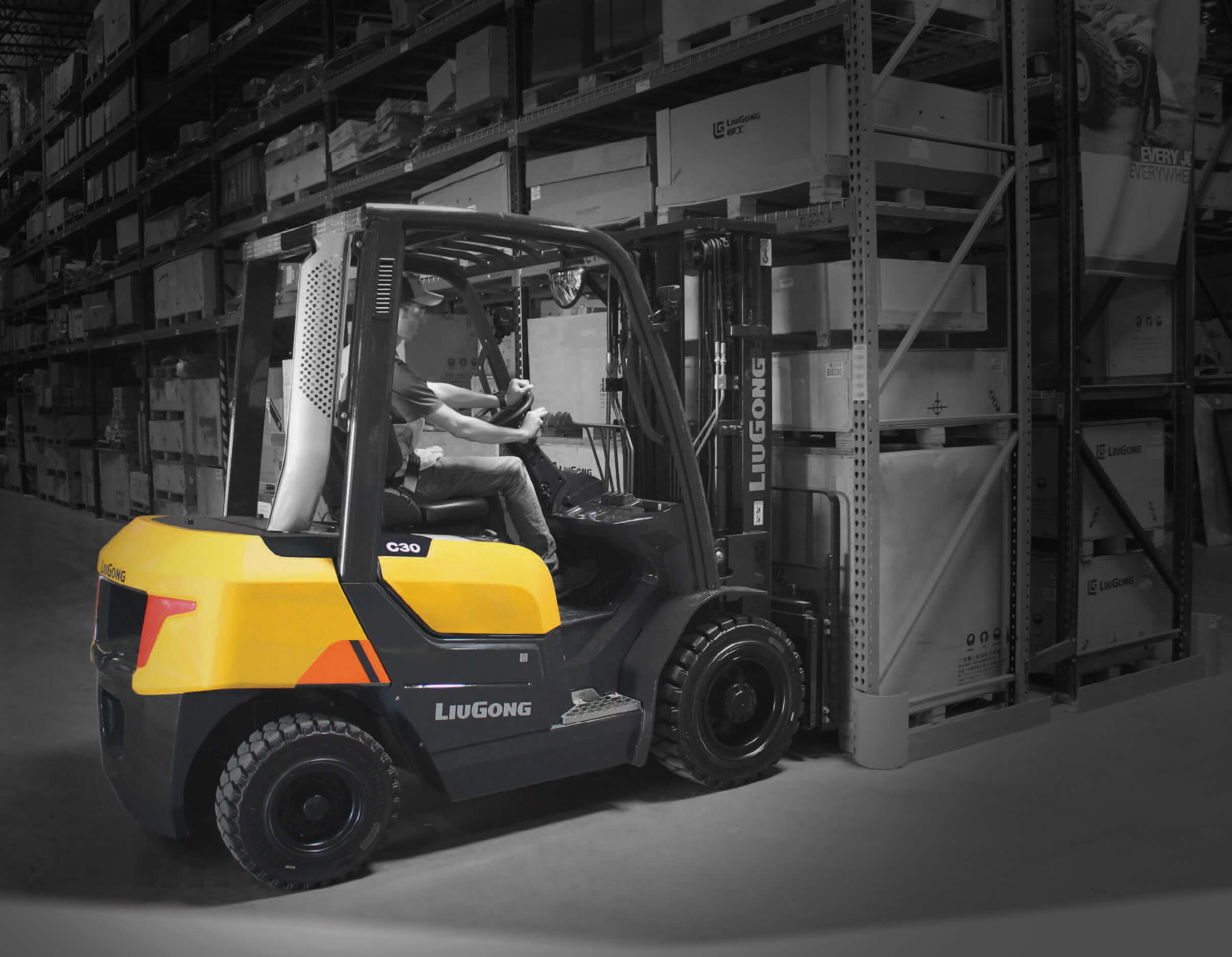 LiuGong forklift in warehouse lifing boxes on pallet out of racking